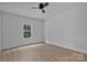 Bedroom featuring wood-look flooring, a ceiling fan, and a bright window at 6133 Long Branch Rd, Salisbury, NC 28147