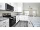 Bright kitchen with stainless steel appliances, white cabinetry, and granite countertops at 6133 Long Branch Rd, Salisbury, NC 28147