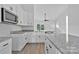 Modern kitchen featuring granite countertops and white cabinetry at 6133 Long Branch Rd, Salisbury, NC 28147