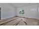 Bright living room with neutral walls, ceiling fan, and a white front door at 6133 Long Branch Rd, Salisbury, NC 28147