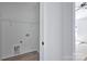 Utility room with white walls, wire shelving, and hookups for a washer and dryer at 6133 Long Branch Rd, Salisbury, NC 28147