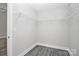 Walk-in closet with white wire shelving and modern gray wood-look flooring at 6133 Long Branch Rd, Salisbury, NC 28147