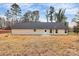 Backyard of a home with beige siding, a black roof, and a small patio in the center at 6147 Long Branch Rd, Salisbury, NC 28147