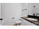 Bathroom with a white toilet, dark countertops, a sink, and a mirror at 6147 Long Branch Rd, Salisbury, NC 28147