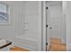Bathroom features a shower-tub combination with white walls and a window for natural light at 6147 Long Branch Rd, Salisbury, NC 28147
