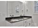 Bathroom features a double sink vanity with dark countertop and modern fixtures at 6147 Long Branch Rd, Salisbury, NC 28147