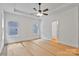 Well-lit bedroom featuring a ceiling fan and multiple windows, next to an open doorway at 6147 Long Branch Rd, Salisbury, NC 28147
