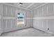 A grey bedroom with the sheetrock up and a single window in the room at 6147 Long Branch Rd, Salisbury, NC 28147