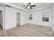 Bright bedroom featuring tray ceiling, ceiling fan and light gray flooring at 6147 Long Branch Rd, Salisbury, NC 28147