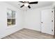 Bright bedroom with light hard wood floors, a modern ceiling fan, and plenty of natural light from the window at 6147 Long Branch Rd, Salisbury, NC 28147