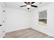 Bright bedroom with light hard wood floors, a modern ceiling fan, and plenty of natural light from the window at 6147 Long Branch Rd, Salisbury, NC 28147