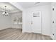Bright entryway featuring wood-look flooring, a modern chandelier, and a white front door with glass panel at 6147 Long Branch Rd, Salisbury, NC 28147
