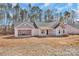 New construction of a home with beige siding, a grey roof, and an attached two car garage at 6147 Long Branch Rd, Salisbury, NC 28147