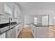 Close-up of the kitchen with white cabinetry, granite countertops, and stainless steel sink at 6147 Long Branch Rd, Salisbury, NC 28147