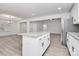 Open-concept kitchen with granite island, white cabinetry, and stainless steel refrigerator at 6147 Long Branch Rd, Salisbury, NC 28147