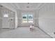 Unfinished room featuring a large window offering natural light, drywall walls and concrete flooring at 6147 Long Branch Rd, Salisbury, NC 28147