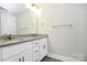 Bathroom vanity with a granite countertop, double sinks, and white cabinets at 6155 Long Branch Rd, Salisbury, NC 28147
