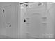 All-white bathroom featuring a shower with a handheld sprayer, and door at 6155 Long Branch Rd, Salisbury, NC 28147