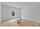 Bright bedroom with large window and flooring partially installed at 6155 Long Branch Rd, Salisbury, NC 28147