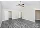 Spacious bedroom features a ceiling fan, neutral walls, and gray wood-look floors at 6155 Long Branch Rd, Salisbury, NC 28147