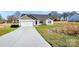 Exterior view of the home with a long driveway and attached two car garage at 6155 Long Branch Rd, Salisbury, NC 28147
