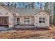 Exterior view of a home under construction, featuring white-framed windows and a covered front porch at 6155 Long Branch Rd, Salisbury, NC 28147