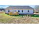 Back of the house with a wood deck, vinyl siding, and a few windows at 6155 Long Branch Rd, Salisbury, NC 28147
