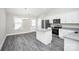 Open-concept kitchen featuring an island, stainless steel appliances, and vinyl flooring at 6155 Long Branch Rd, Salisbury, NC 28147