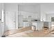 Bright, white kitchen featuring an open floor plan connecting the dining area, and kitchen at 6155 Long Branch Rd, Salisbury, NC 28147