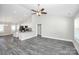 Spacious living area showcasing a bright open floor plan, with gray wood floors, and a ceiling fan at 6155 Long Branch Rd, Salisbury, NC 28147