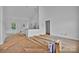 Bright, white interior featuring an open floor plan connecting the living room, dining area, and kitchen at 6155 Long Branch Rd, Salisbury, NC 28147