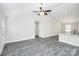 Bright, open living room with vaulted ceiling, ceiling fan, and modern gray wood flooring at 6155 Long Branch Rd, Salisbury, NC 28147