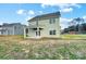 Backyard featuring a covered patio, green lawn, and view of a neighboring home at 11507 Valley Oaks Ln, Stanfield, NC 28163