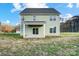 Backyard featuring a covered patio, green lawn, and view of the surrounding trees at 11507 Valley Oaks Ln, Stanfield, NC 28163
