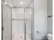 Modern bathroom featuring a glass-enclosed shower with white tile and fixtures at 11507 Valley Oaks Ln, Stanfield, NC 28163
