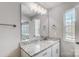 Clean bathroom features a large mirror, a granite vanity, modern lights, and a backyard view at 11507 Valley Oaks Ln, Stanfield, NC 28163