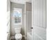 Bathroom with a toilet, window, and an alcove tub/shower with white tile at 11507 Valley Oaks Ln, Stanfield, NC 28163