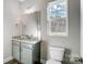 Well-lit bathroom featuring a granite vanity, window with backyard view, and modern fixtures and hardware at 11507 Valley Oaks Ln, Stanfield, NC 28163