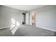 Spacious bedroom featuring neutral walls, plush carpet, and a view into the adjacent bathroom at 11507 Valley Oaks Ln, Stanfield, NC 28163