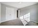 Bedroom with carpet, neutral walls and trim, and features an adjacent closet and doorway at 11507 Valley Oaks Ln, Stanfield, NC 28163