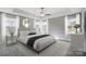 Bedroom with neutral walls, tray ceilings, plush carpet, and dual windows at 11507 Valley Oaks Ln, Stanfield, NC 28163
