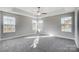 Spacious bedroom featuring neutral walls, plush carpet, tray ceiling and dual windows at 11507 Valley Oaks Ln, Stanfield, NC 28163