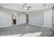 A spacious bedroom featuring plush carpeting, natural light, with entrances to bathroom and closet at 11507 Valley Oaks Ln, Stanfield, NC 28163