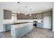 Modern kitchen featuring granite countertops, stainless steel appliances, grey cabinets, and a stylish central island at 11507 Valley Oaks Ln, Stanfield, NC 28163