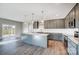 Spacious kitchen boasts an island, gray cabinets, modern appliances, and an open layout, perfect for entertaining at 11507 Valley Oaks Ln, Stanfield, NC 28163