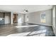 Bright and open living room features sleek floors, large windows, and a staircase leading to the upper level at 11507 Valley Oaks Ln, Stanfield, NC 28163