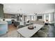 Open layout boasts a modern kitchen with island, a dining area, and a cozy living space filled with natural light at 11507 Valley Oaks Ln, Stanfield, NC 28163