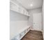 Well-organized mudroom with custom built-in shelving, bench seating, and hooks for convenient storage at 11507 Valley Oaks Ln, Stanfield, NC 28163