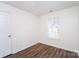 Simple bedroom with hardwood floors and a window at 2327 Hope Valley Ln, Charlotte, NC 28213