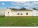 Rear view of a ranch home with a grassy yard at 2327 Hope Valley Ln, Charlotte, NC 28213